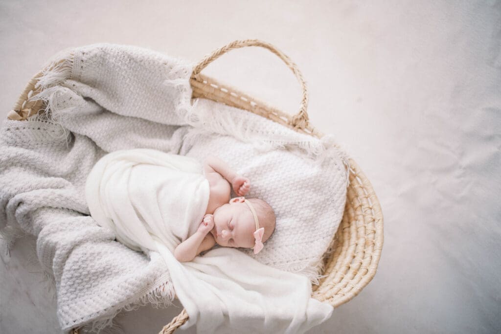 Newborn baby girl wrapped in neutral tones during a Jacksonville newborn photography session
