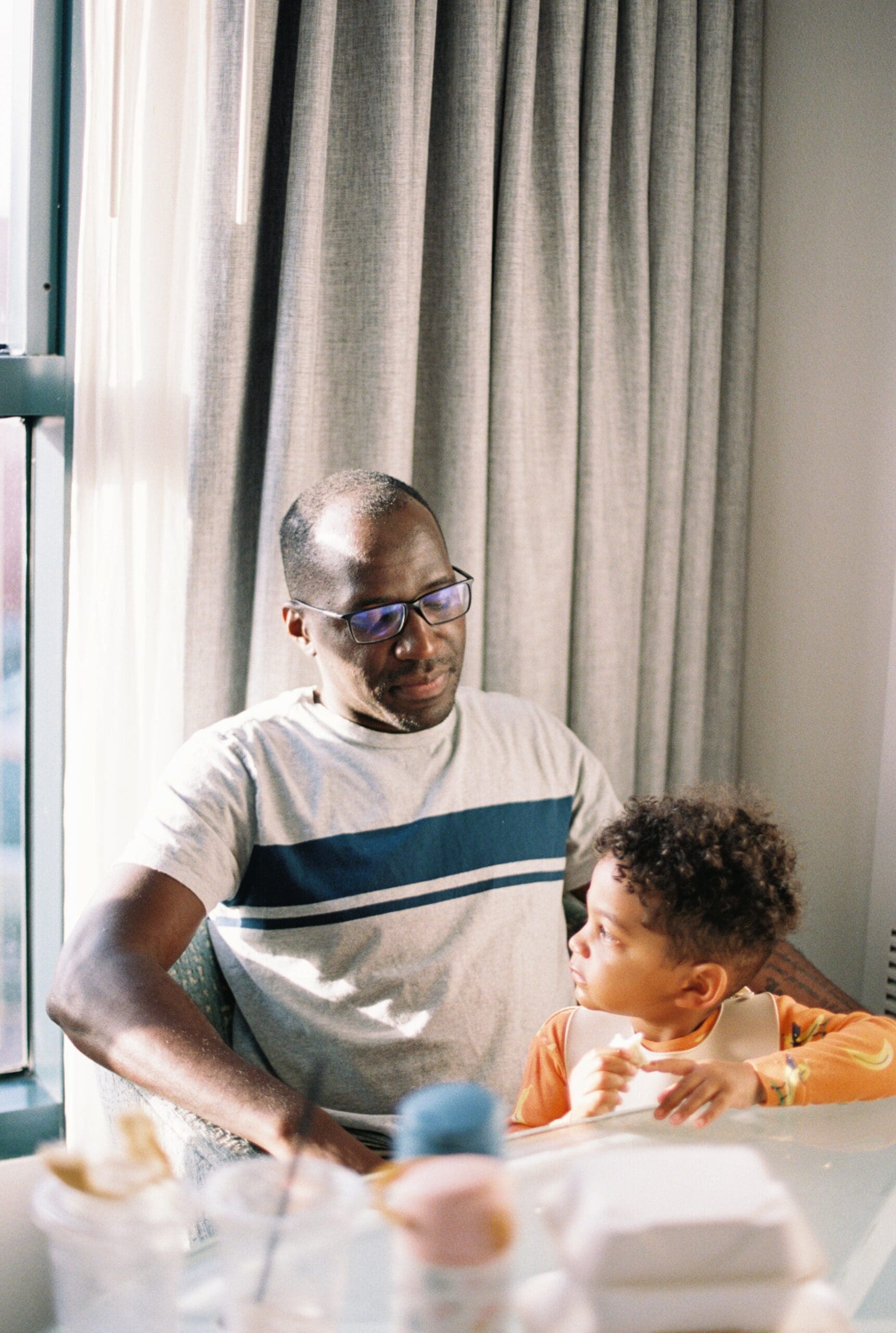 Dad and young son enjoying a meal together at a family-friendly restaurant in Jacksonville, Florida.
