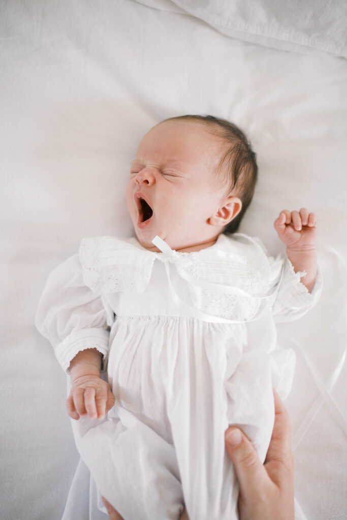 yawning baby in newborn gown in ortega home