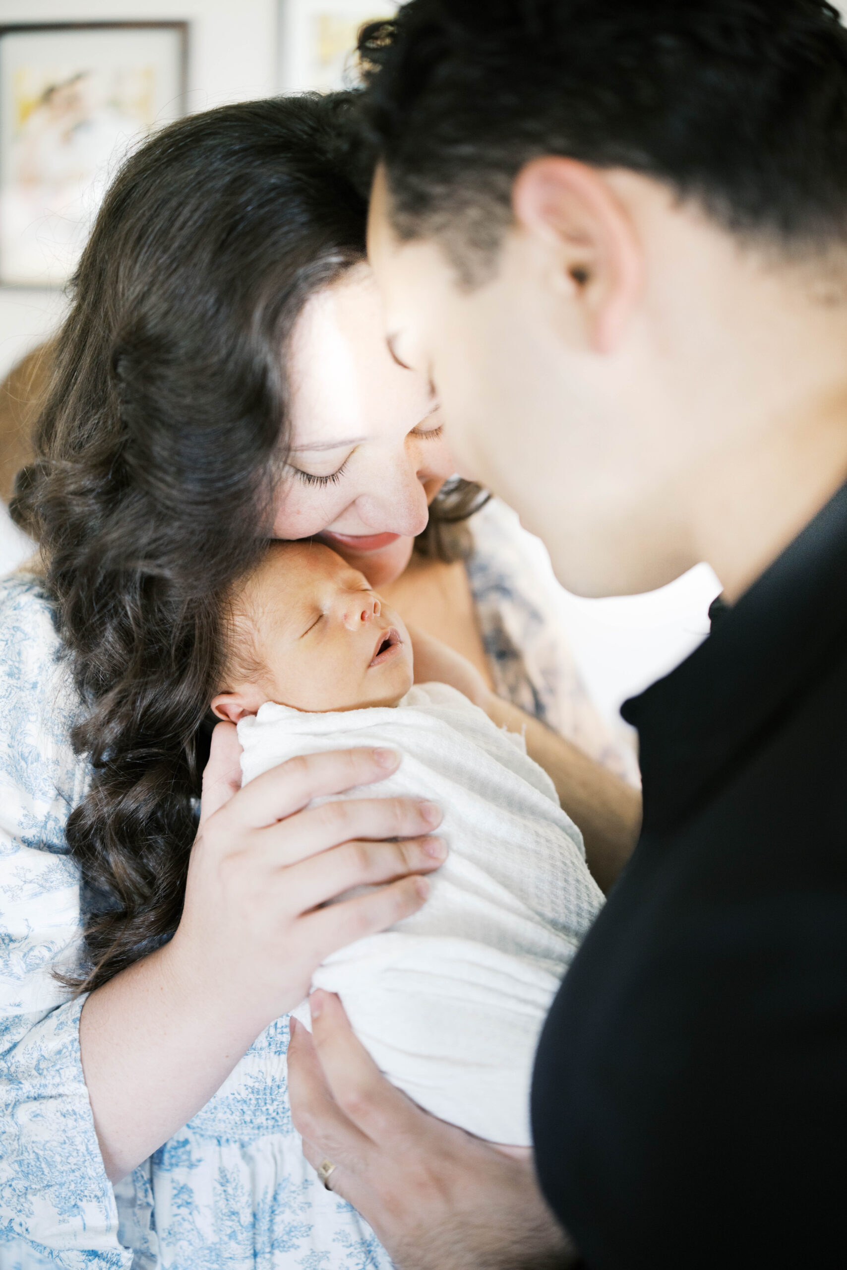 newborn portrait of mother holding baby and father looking at baby in a home in Jacksonville FL